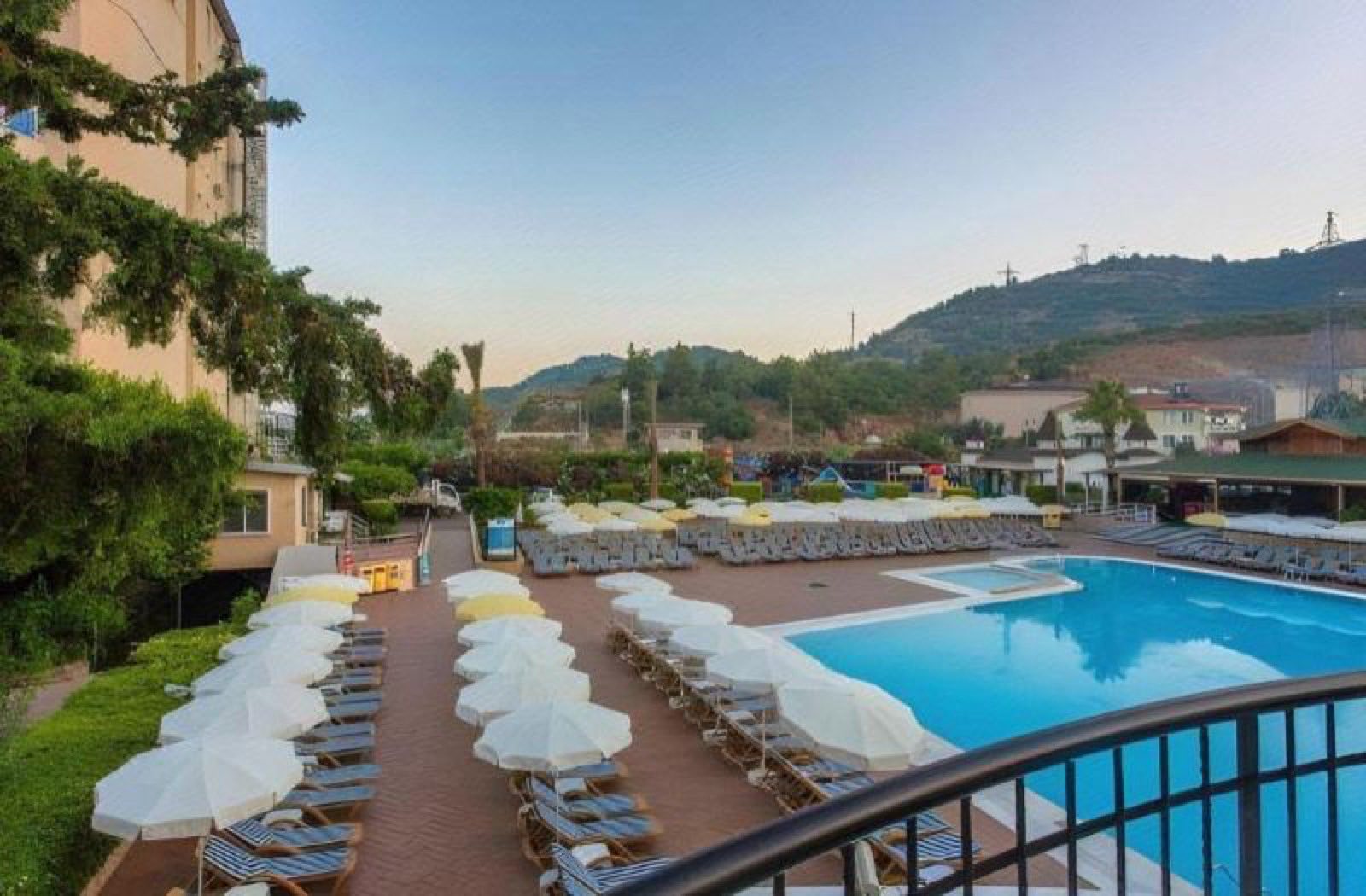 The pools and the hillside seen from a balcony on an upper floor